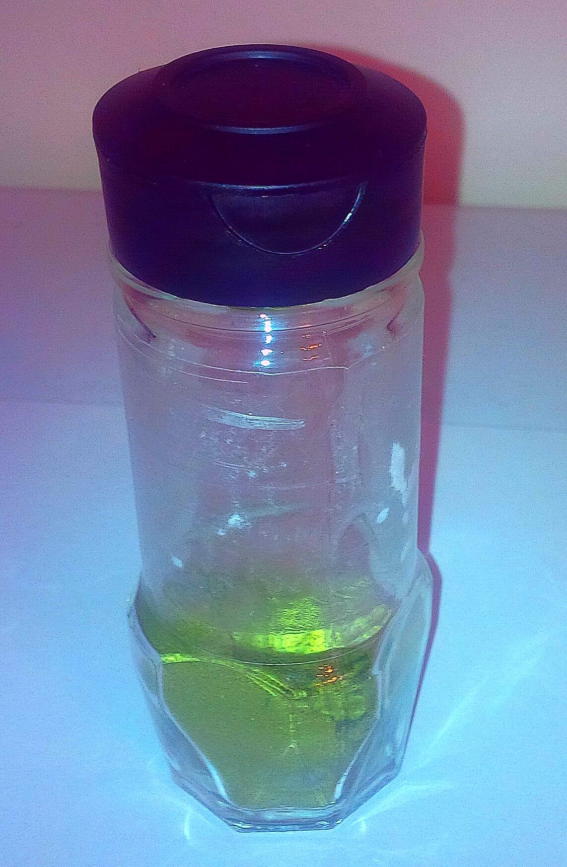 "Partially filled spice jar container with Bilal's EasyKale, an organic tasteless kale powder, showcasing its unique vibrant green color and freshness.
